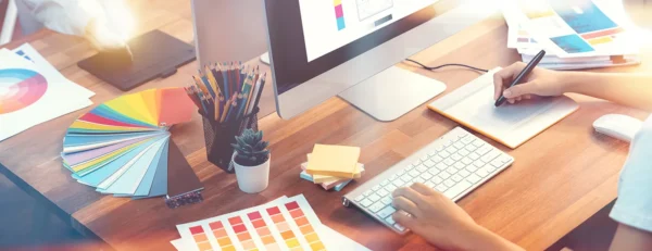 Graphic designer workspace showing in-house design team desktop setup