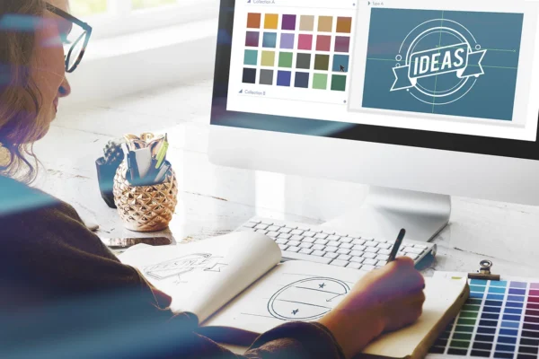 Graphic designer creating branding and marketing concepts at a design workstation