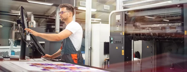 Print operator producing branded packaging materials in a professional print facility