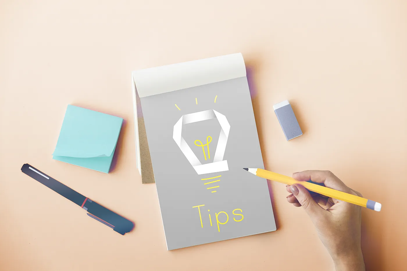 Notebook with “Tips” written inside representing business card design tips